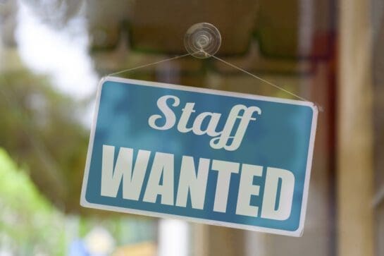 Now hiring sign on glass door